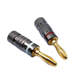 Two metallic banana plugs with gold tips on a white background